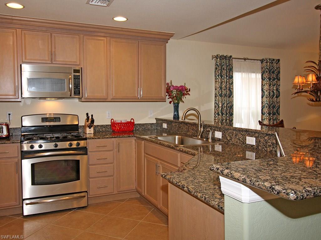 19636 Villa Rosa Loop Estero, FL 33967 - Photo 6 of 21 a kitchen with granite countertop cabinets stainless steel appliances and a counter space