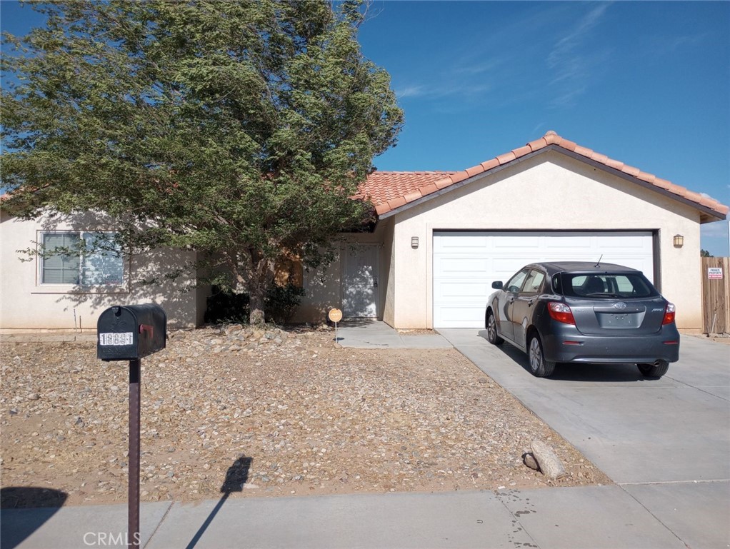 18891 Larkspur Road Adelanto, CA 92301 - Photo 1 of 1 a view of a car in front of a house