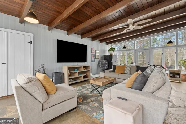 a living room with furniture and a lamp
