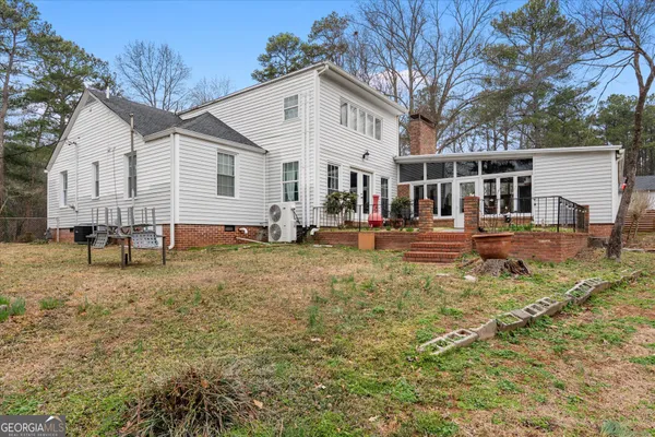 a view of dirt yard with a tree