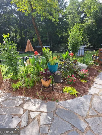 a view of a white house with a yard and tree s