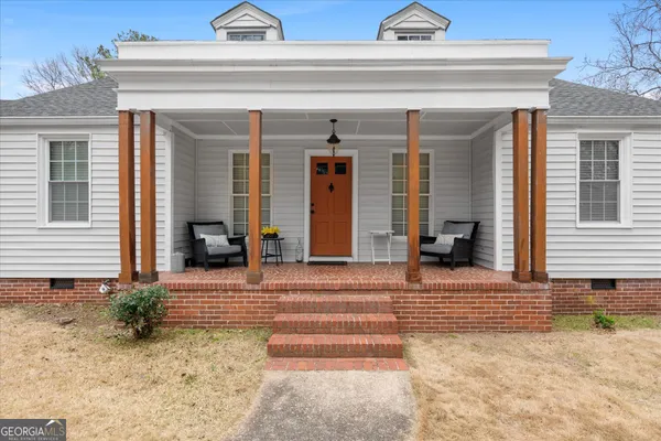 a living room with furniture fireplace and rug
