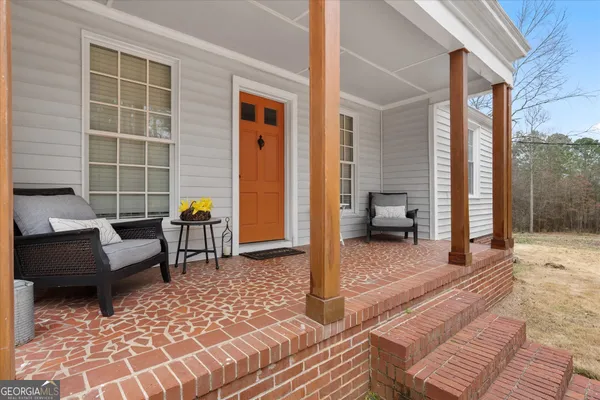 a living room with furniture a rug and a window