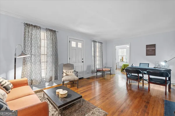 a view of a dining room with furniture wooden floor and a chandelier