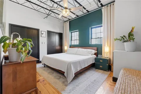 a bedroom with a bed and a potted plant