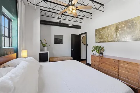 a bed room with a bed and a potted plant