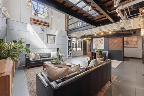 a living room with furniture and a potted plant
