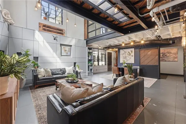 a living room with furniture and a potted plant