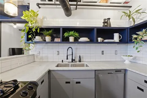 a kitchen with a sink a counter and cabinets