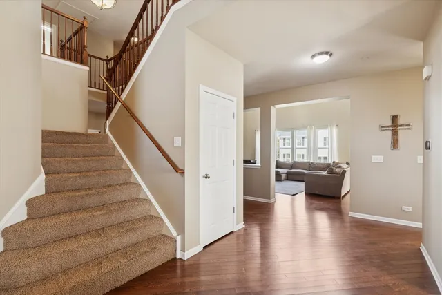 a view of entryway and hall with wooden floor
