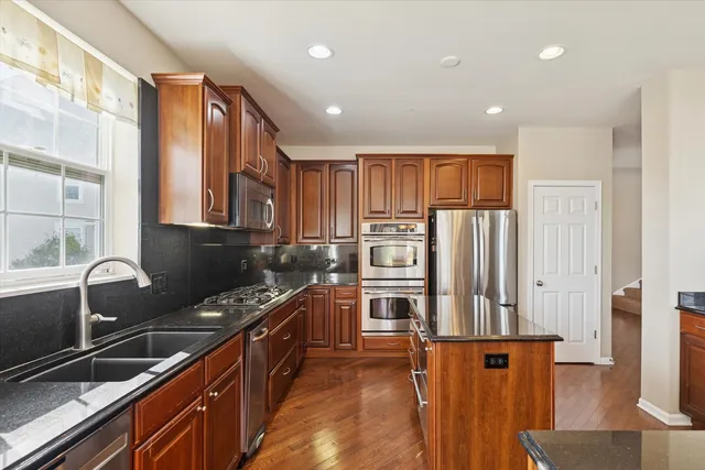 a kitchen with stainless steel appliances a refrigerator and a stove