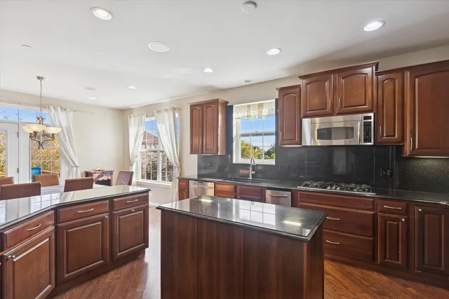 a kitchen with a sink stove and microwave