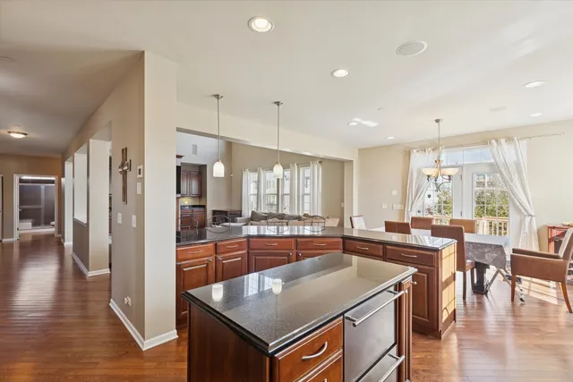a large kitchen with a table and chairs