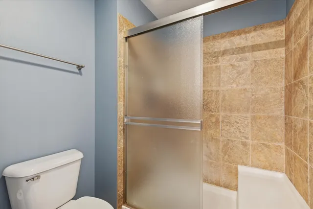 a bathroom with a toilet and a shower