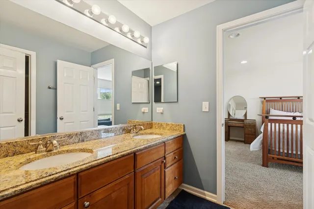 a spacious bathroom with a double vanity sink and a mirror