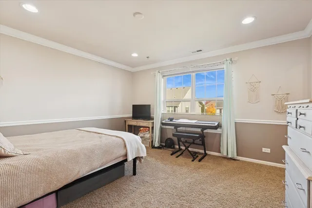 a bedroom with a bed and a desk