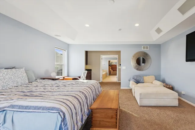 a bedroom with a large bed and a couch