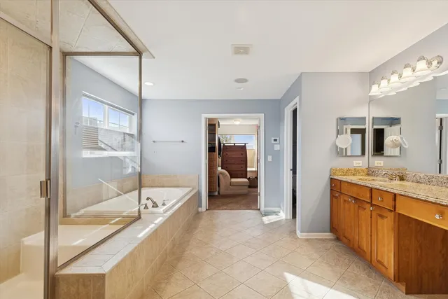 a bathroom with a granite countertop sink mirror bathtub and shower