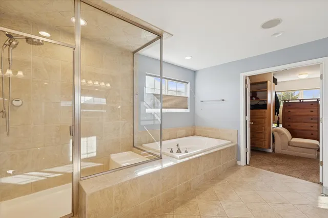 a bathroom with a tub a sink and a shower