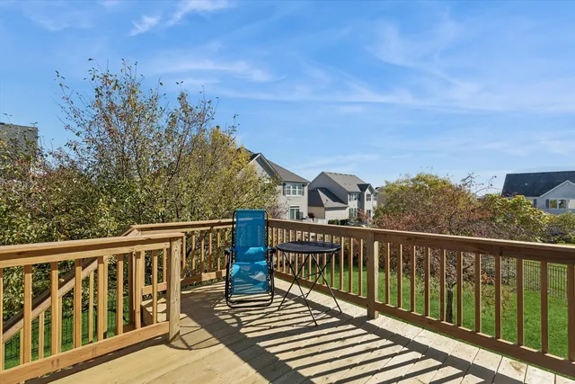 a view of a balcony with wooden floor and fence