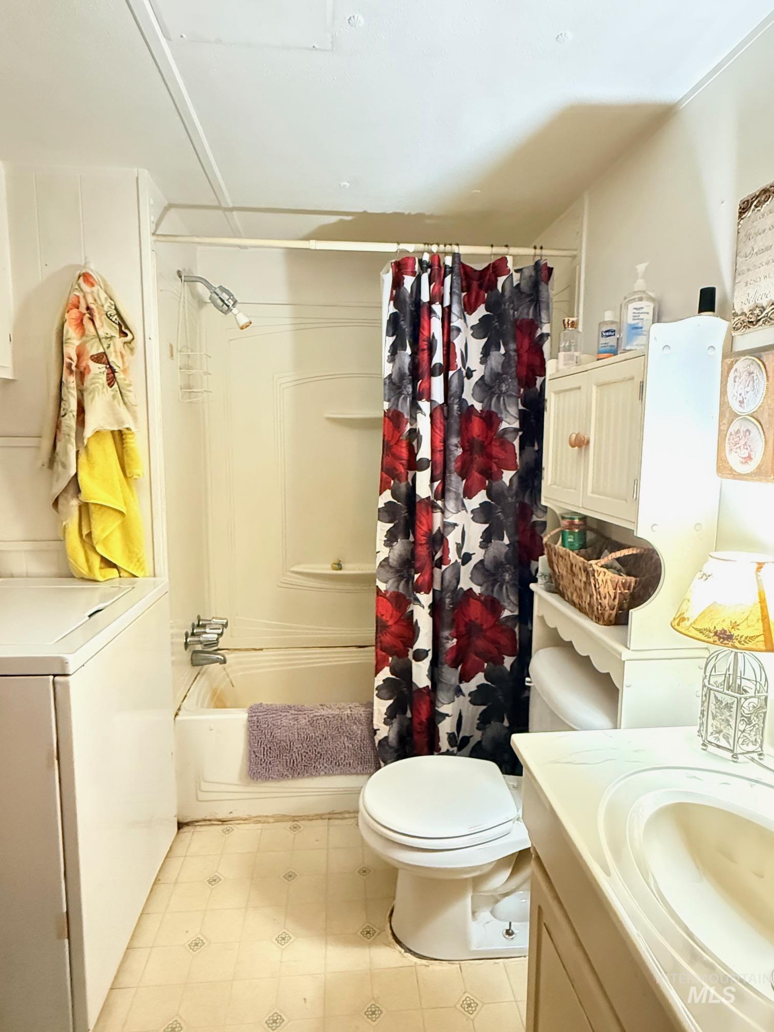 5742 Grangemont Road Orofino, ID 83544 - Photo 13 of 25 Bathroom featuring a white bathtub with an integrated shower, a white toilet, and a vanity with an integrated sink