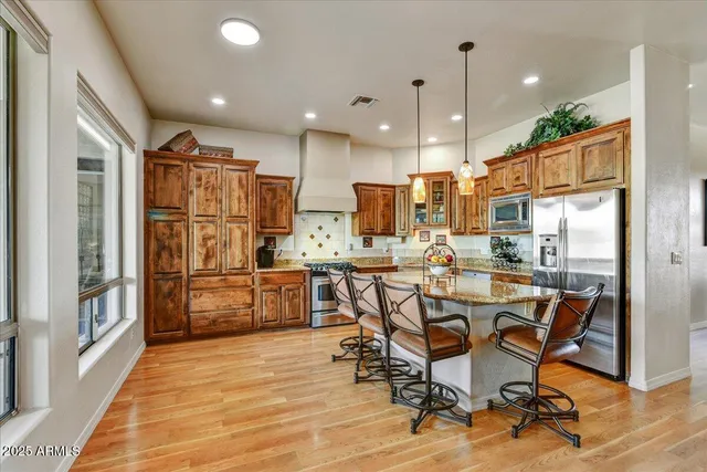 a kitchen with a table chairs sink and cabinets