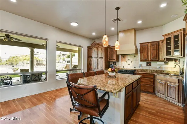a kitchen with stainless steel appliances granite countertop a stove a sink and a microwave