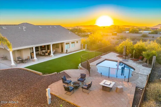 a living room with patio furniture and a floor to ceiling window
