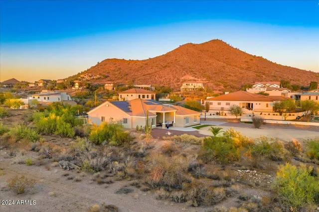 a view of a swimming pool with a table and chairs