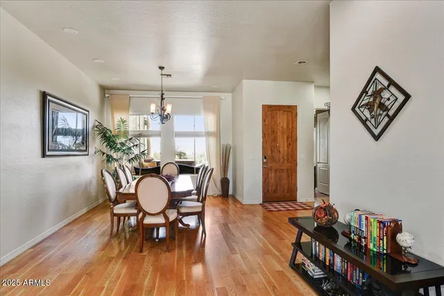 a dining room with furniture and wooden floor