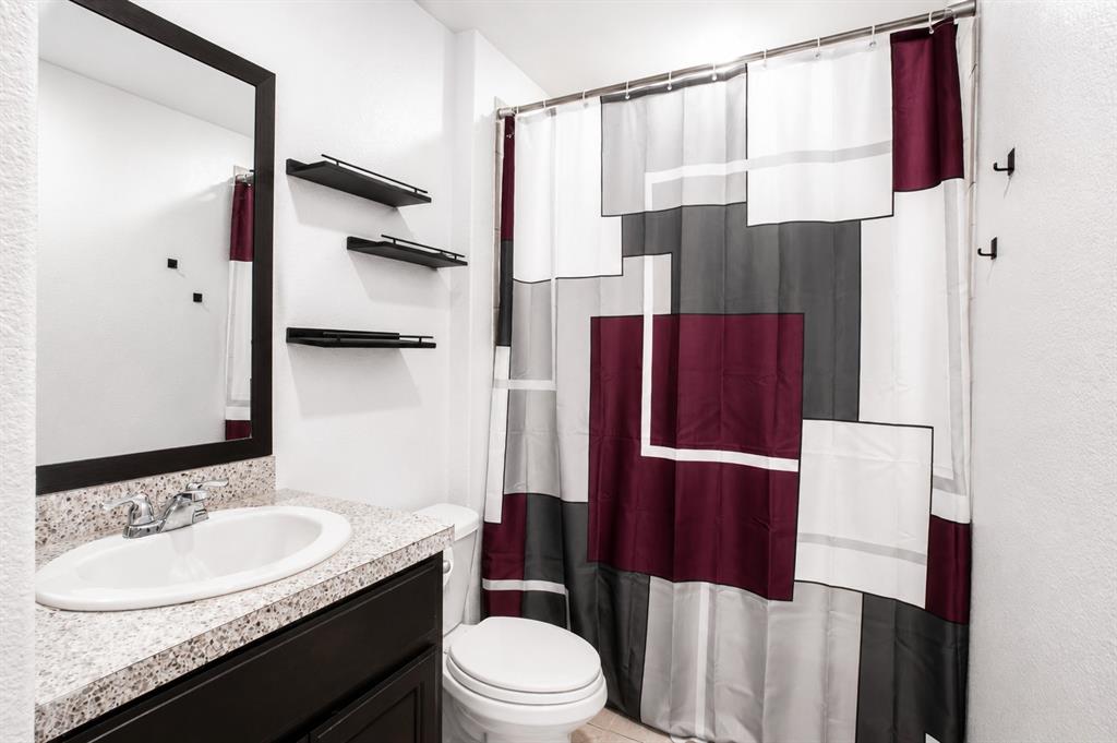 3204 Quiet Valley Road Fort Worth, TX 76123 - Photo 9 of 29 a bathroom with a granite countertop sink toilet and shower
