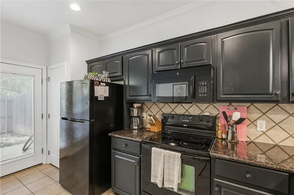 a kitchen with granite countertop stainless steel appliances and wooden cabinets