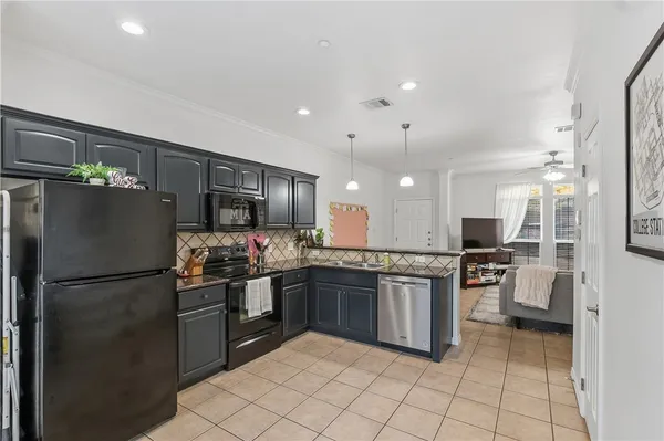 a kitchen with stainless steel appliances granite countertop a refrigerator and a sink