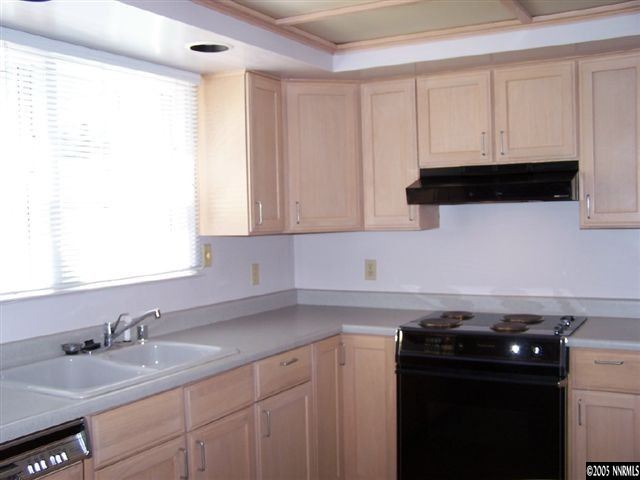 675 Candy Avenue Reno, NV 89509 - Photo 4 of 8 a kitchen with granite countertop white cabinets and a stove