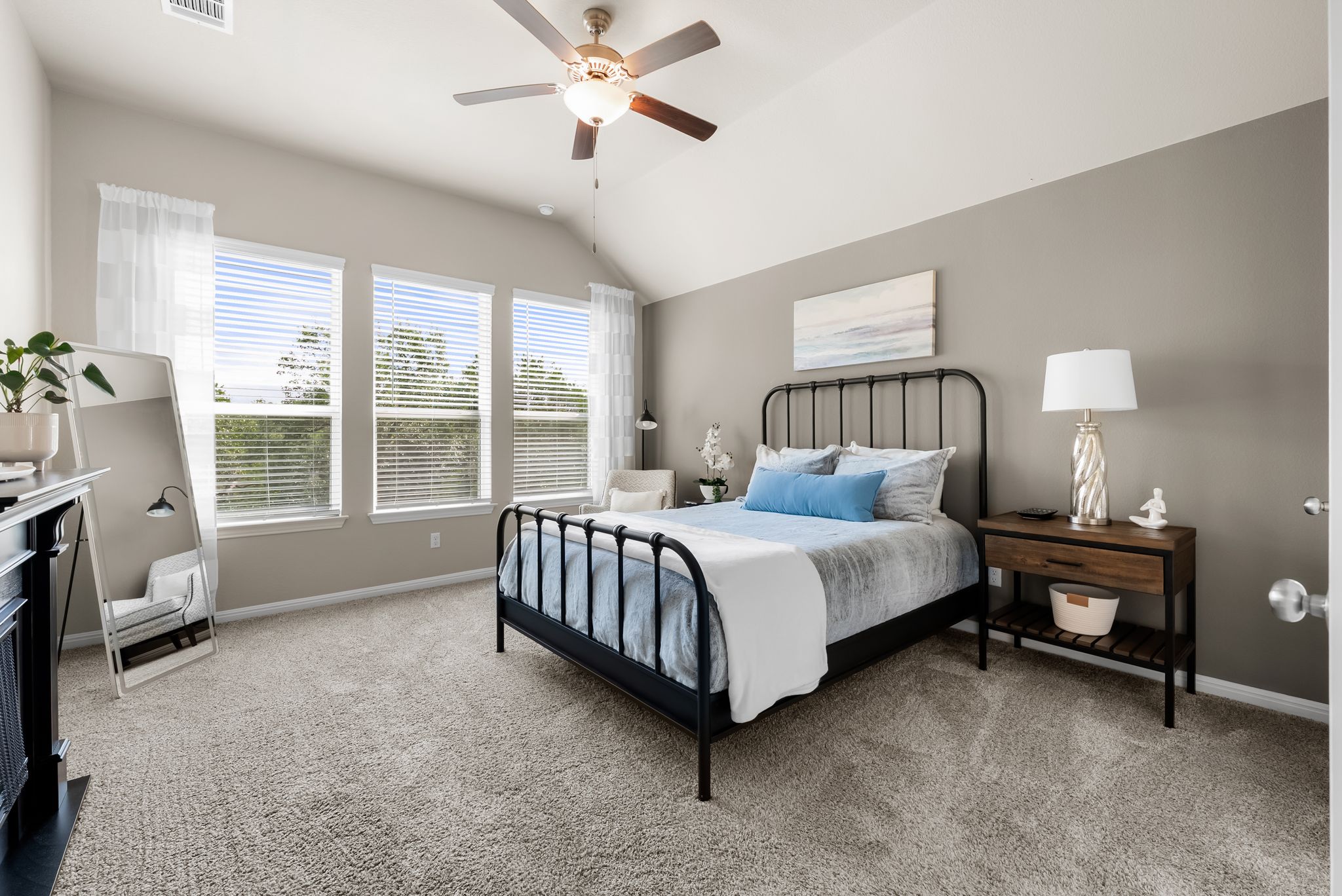 300 Prato Place Georgetown, TX 78628 - Photo 16 of 40 A well-lit bedroom features vaulted ceilings and ample natural light from multiple windows.