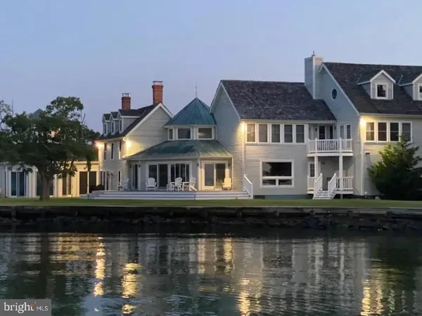 a front view of a house with lake view and a yard