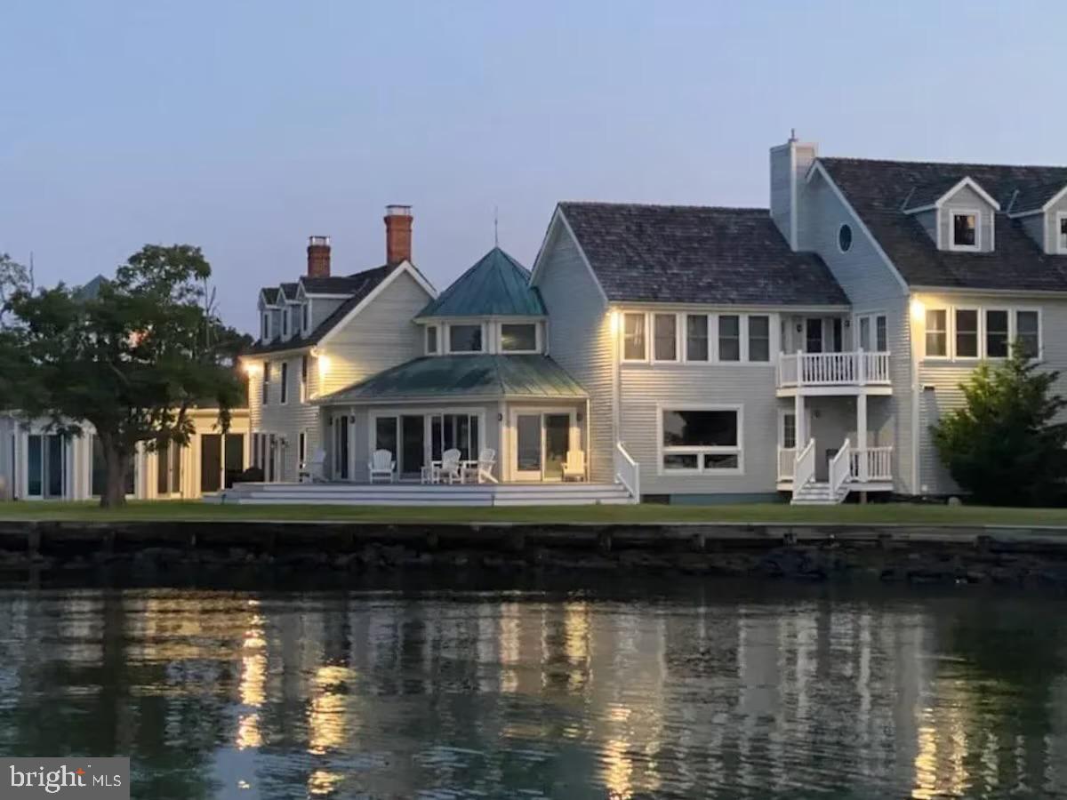 a front view of a house with lake view and a yard