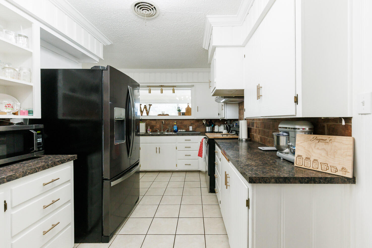 2718 55th Street Lubbock, TX 79413 - Photo 12 of 58 a kitchen with stainless steel appliances granite countertop a refrigerator and a stove