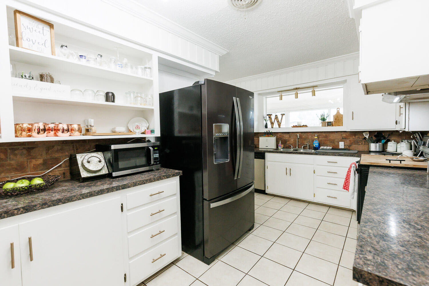 2718 55th Street Lubbock, TX 79413 - Photo 13 of 58 a kitchen with stainless steel appliances granite countertop a refrigerator and a stove