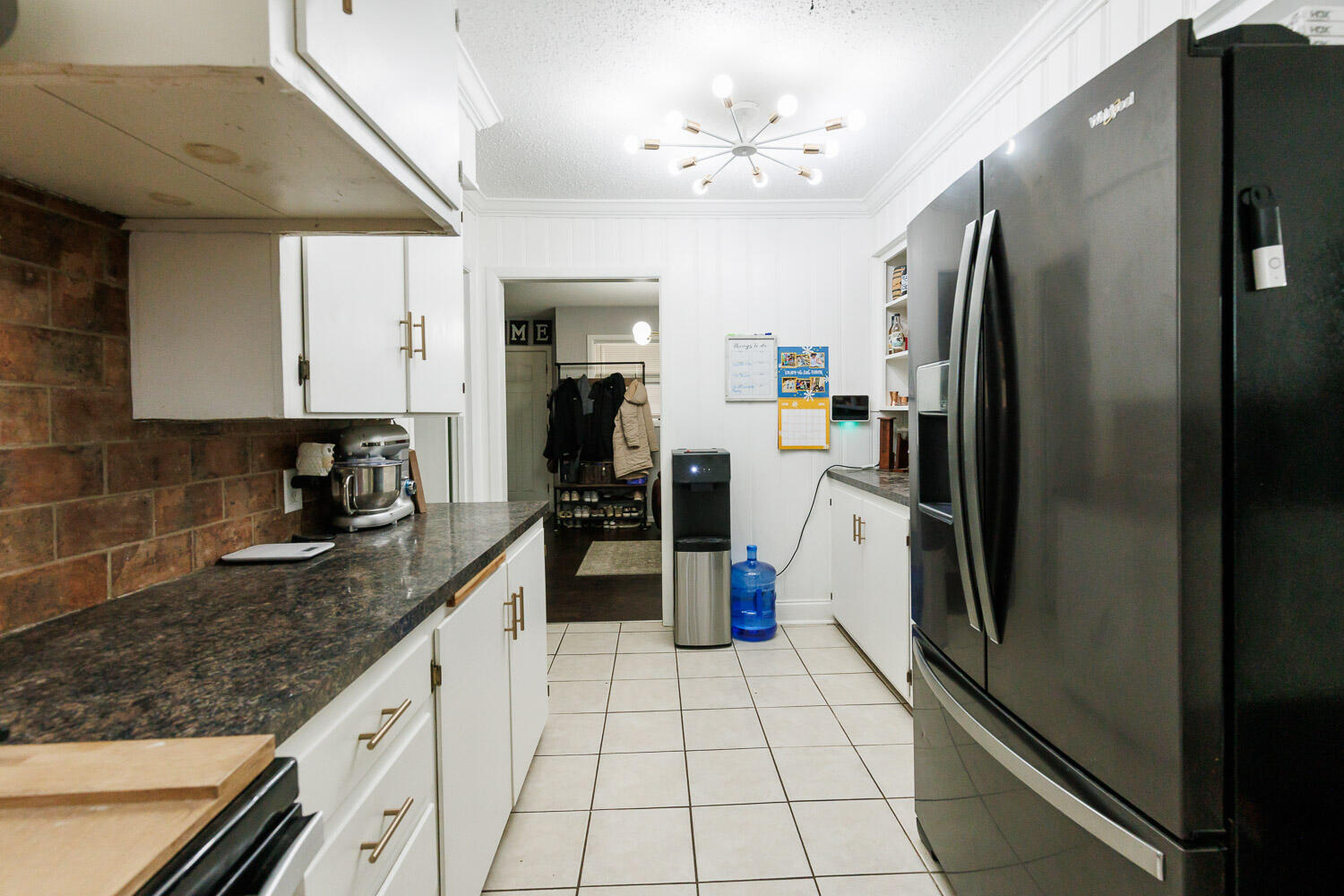 2718 55th Street Lubbock, TX 79413 - Photo 18 of 58 a kitchen with a refrigerator a sink and cabinets