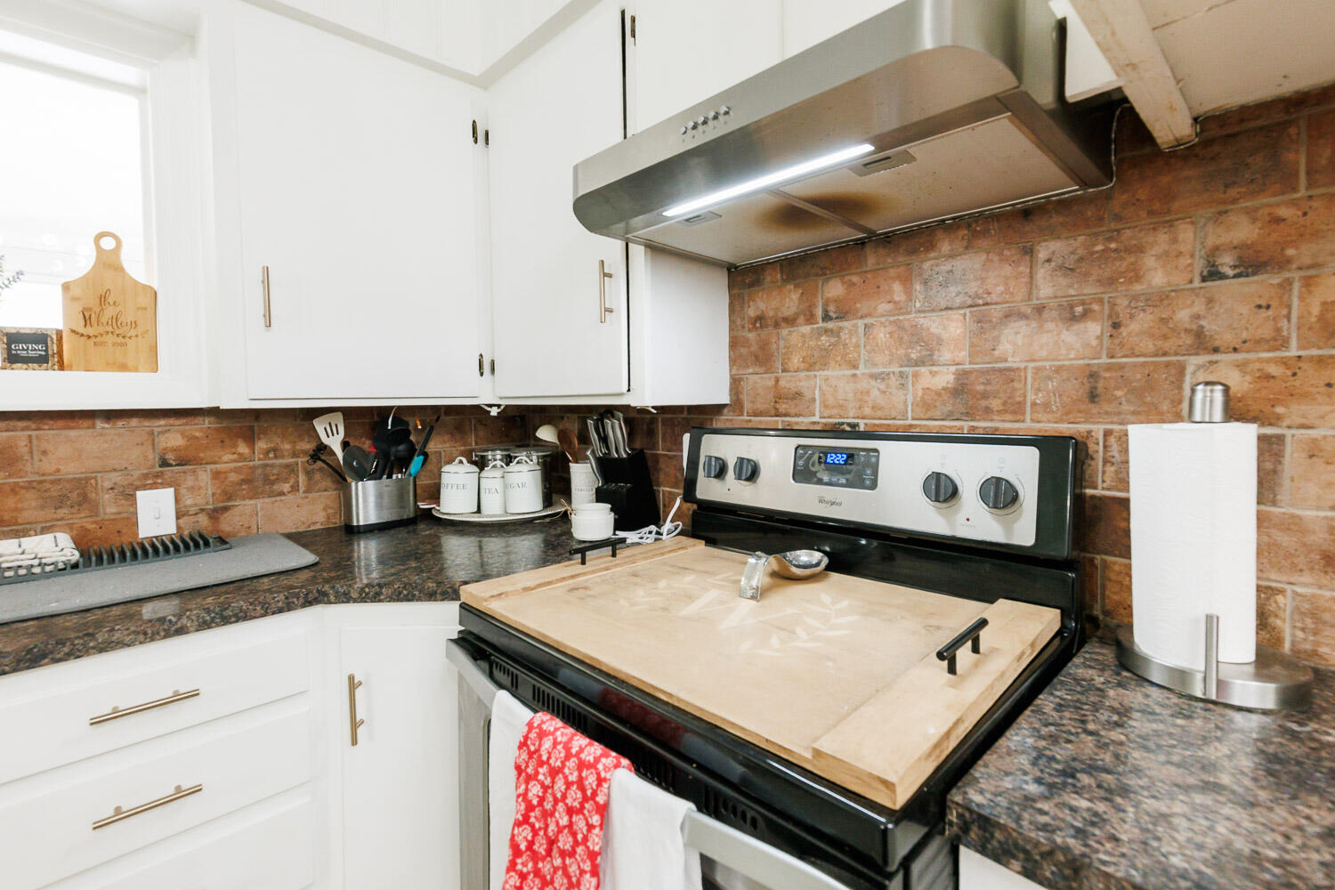 2718 55th Street Lubbock, TX 79413 - Photo 19 of 58 a kitchen with a stove a sink and cabinets