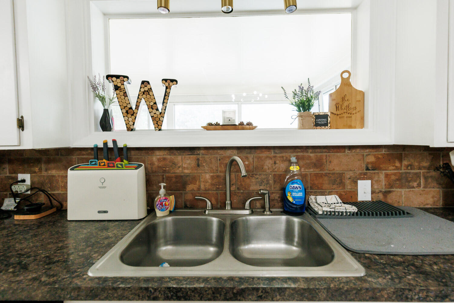 2718 55th Street Lubbock, TX 79413 - Photo 20 of 58 a kitchen sink with granite countertop a sink and a wooden floor