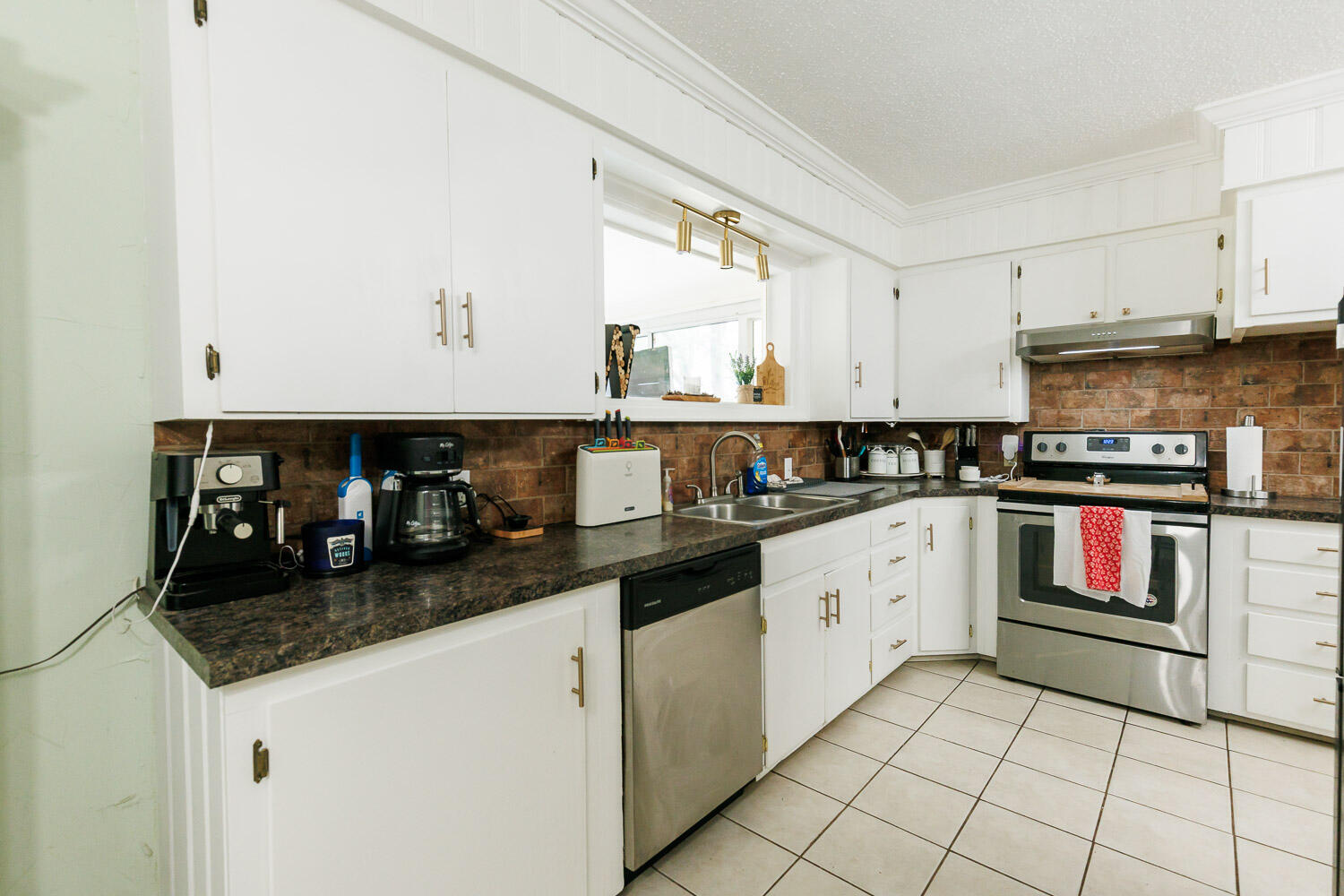2718 55th Street Lubbock, TX 79413 - Photo 23 of 58 a kitchen with stainless steel appliances granite countertop a stove and a sink