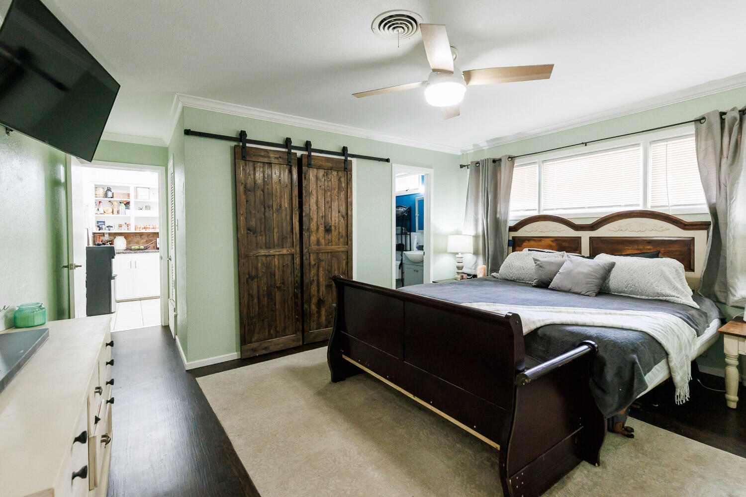 2718 55th Street Lubbock, TX 79413 - Photo 26 of 58 a bedroom with a bed and a large mirror