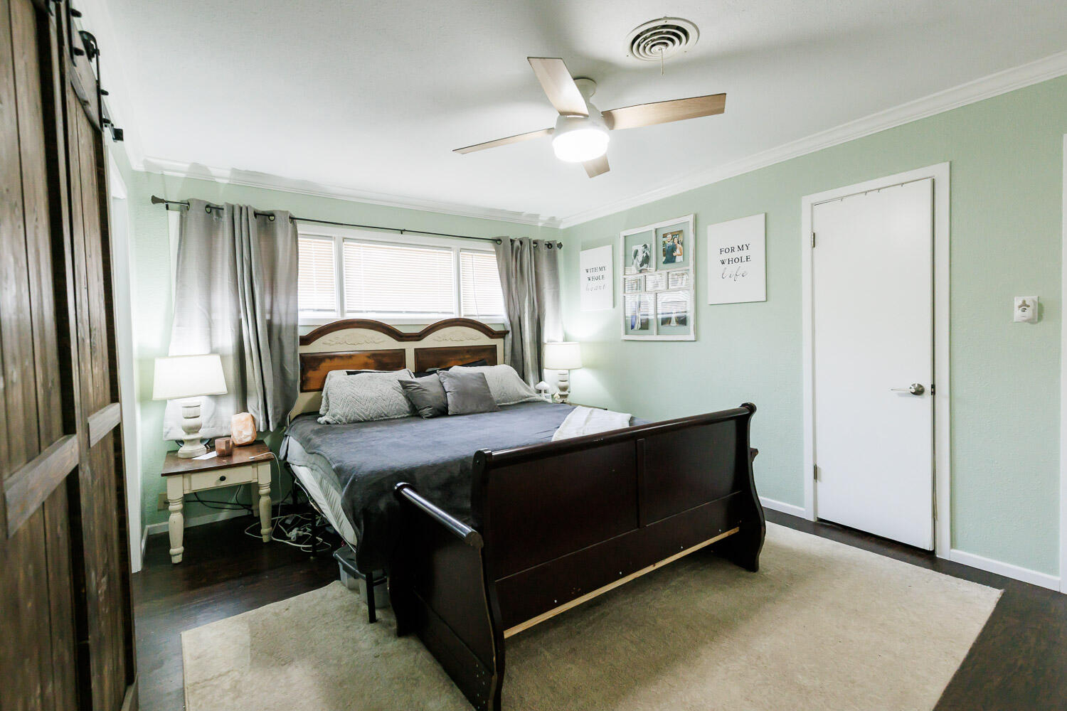 2718 55th Street Lubbock, TX 79413 - Photo 27 of 58 a bedroom with a bed and a chandelier
