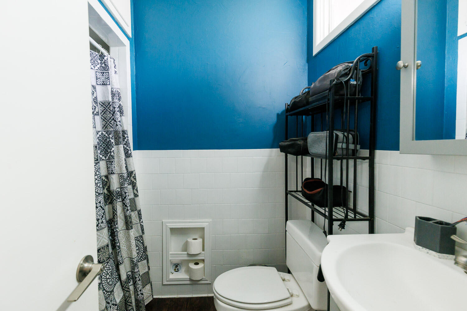 2718 55th Street Lubbock, TX 79413 - Photo 30 of 58 a bathroom with a toilet and shower curtain