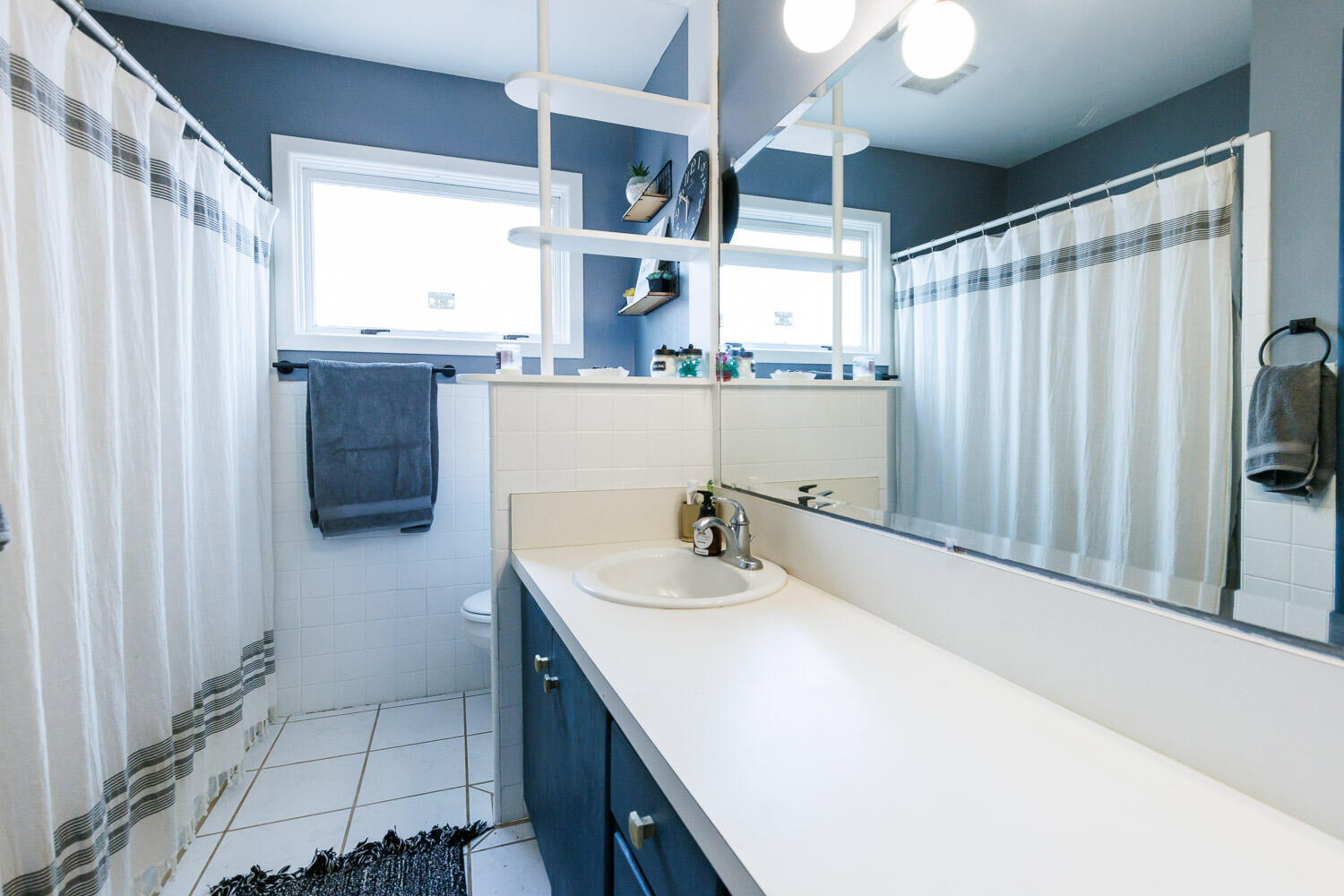 2718 55th Street Lubbock, TX 79413 - Photo 36 of 58 a bathroom with a sink and a mirror