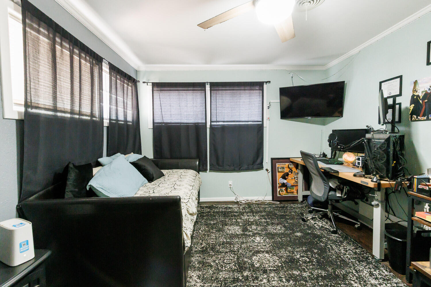 2718 55th Street Lubbock, TX 79413 - Photo 38 of 58 a bedroom with furniture a flat screen tv and a window