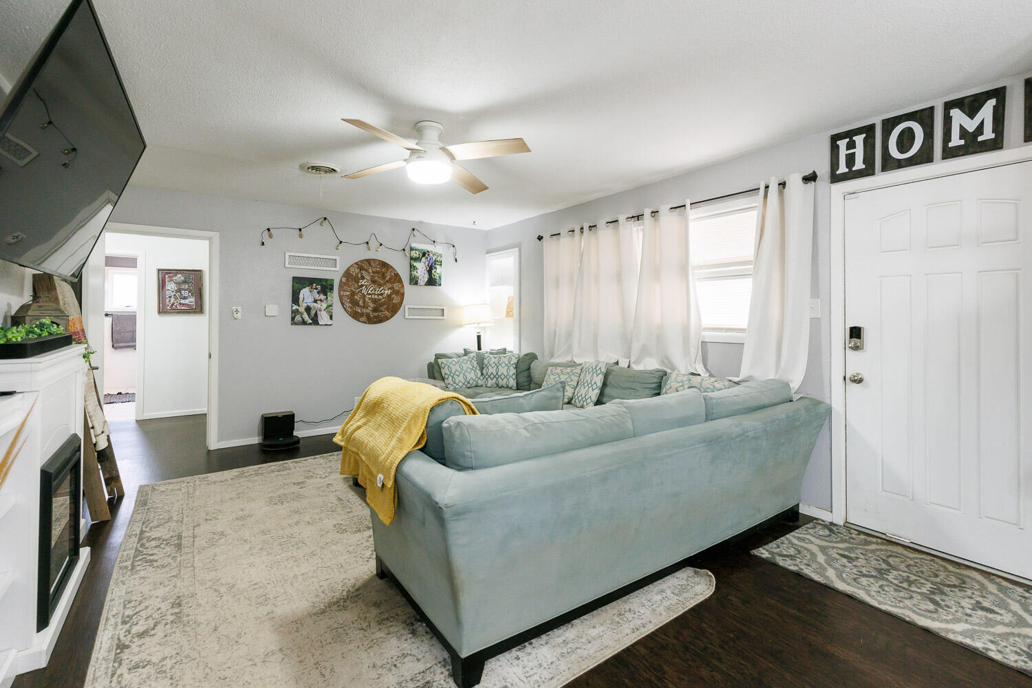 2718 55th Street Lubbock, TX 79413 - Photo 4 of 58 a living room with furniture and a flat screen tv