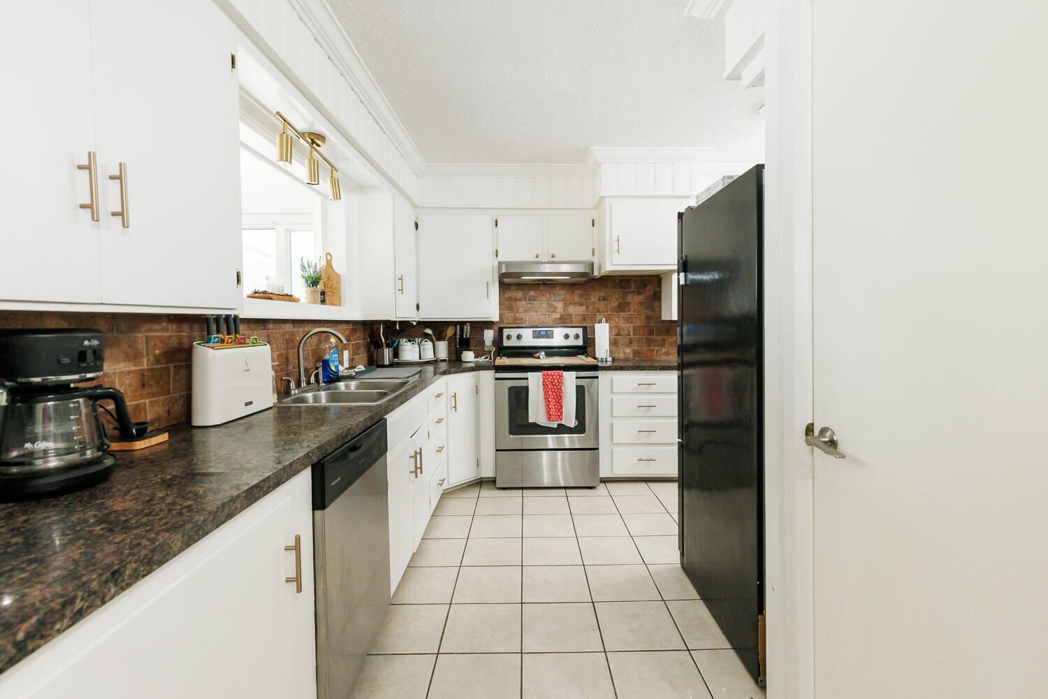 2718 55th Street Lubbock, TX 79413 - Photo 46 of 58 a kitchen with stainless steel appliances granite countertop a refrigerator and a stove